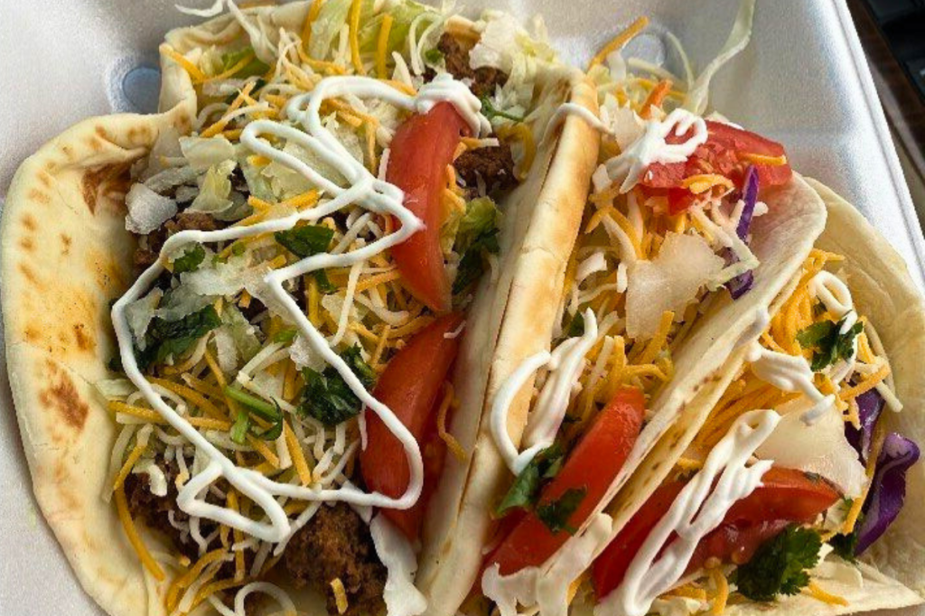 A plate of takeout food (tacos) from windy city bites